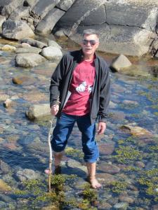 Man cooling off in a river during a Dome build in Sweden