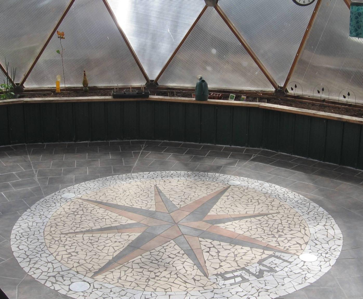 brick and mosaic flooring inside of geodesic greenhouse
