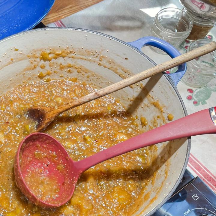 making fig jam in a large blue enameled pot