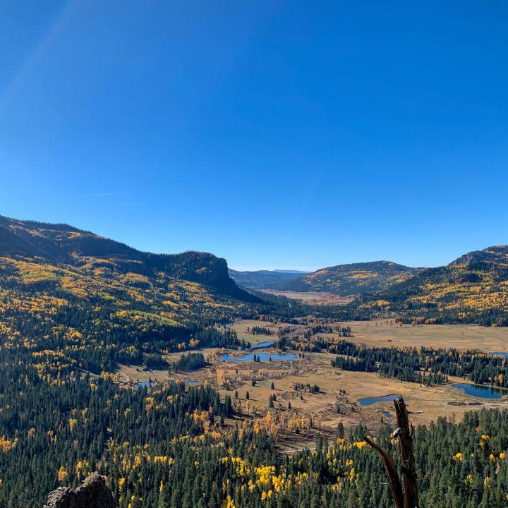 Vantage point from the overlook on Wolf Creek Pass looking down the Pagosa Springs valley with yellow aspens dotting the mountains