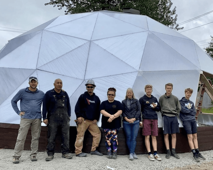 people in front of geodesic dome