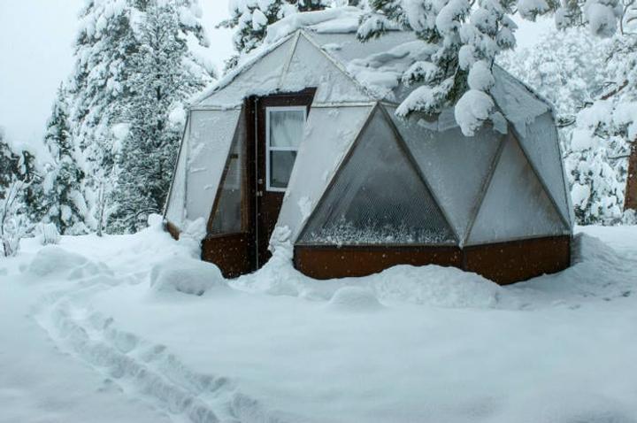 fully build geodesic dome greenhouse during winter in the mountains