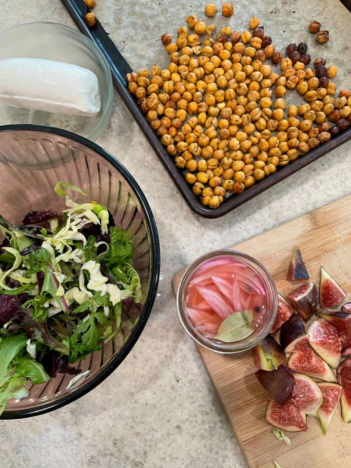 final salad assembly dressed greens chopped figs pickled onions goat cheese toasted garbanzos