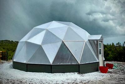 26 foot diameter growing dome greenhouse surrounded by hail and dark sky