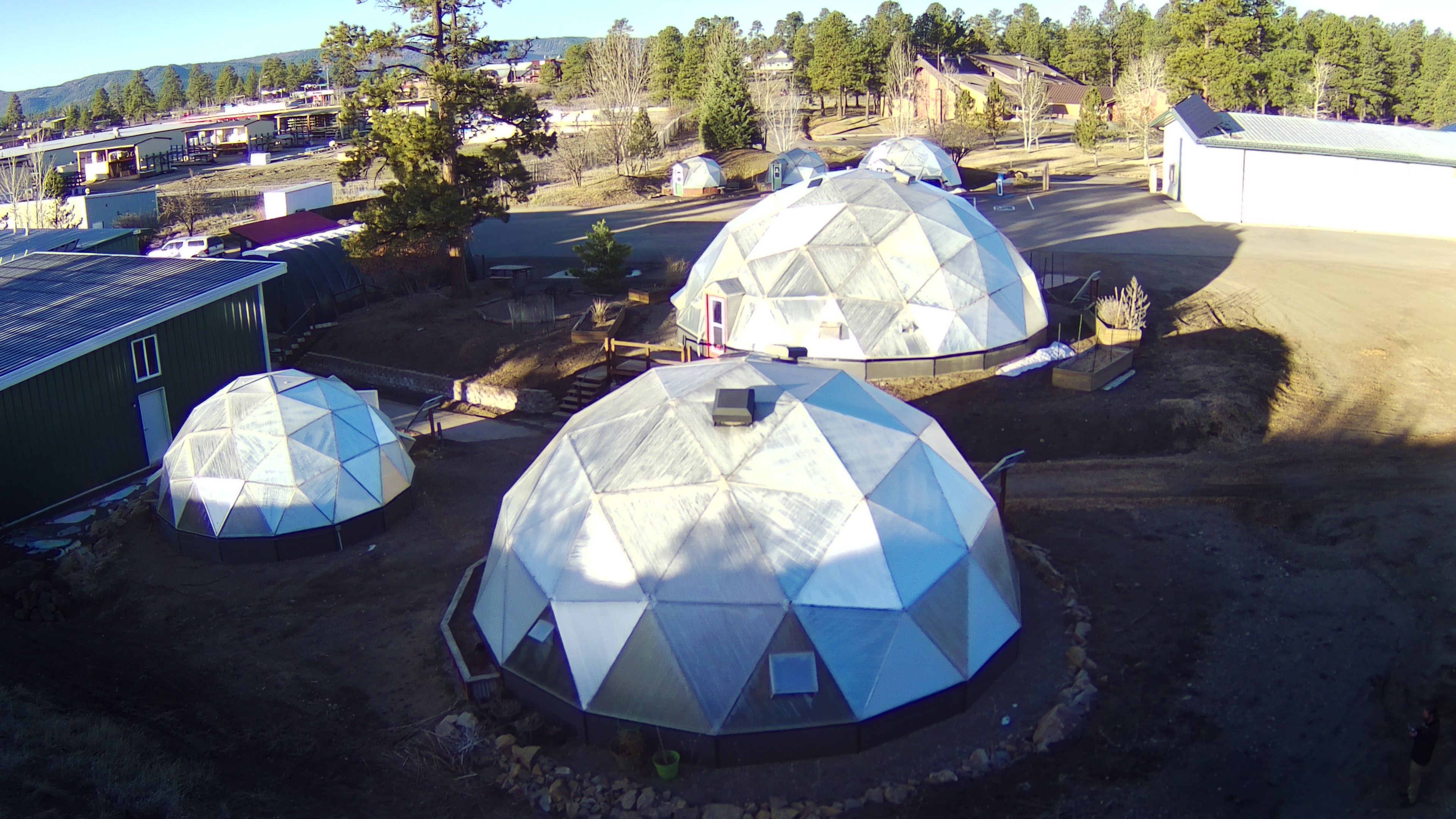 Aerial photo of six Growing Dome greenhouses in Pagosa Springs, Colorado