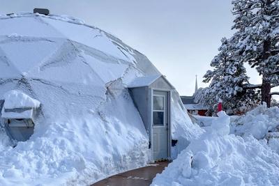 Growing Dome greenhouse at Growing Spaces campus in deep snow
