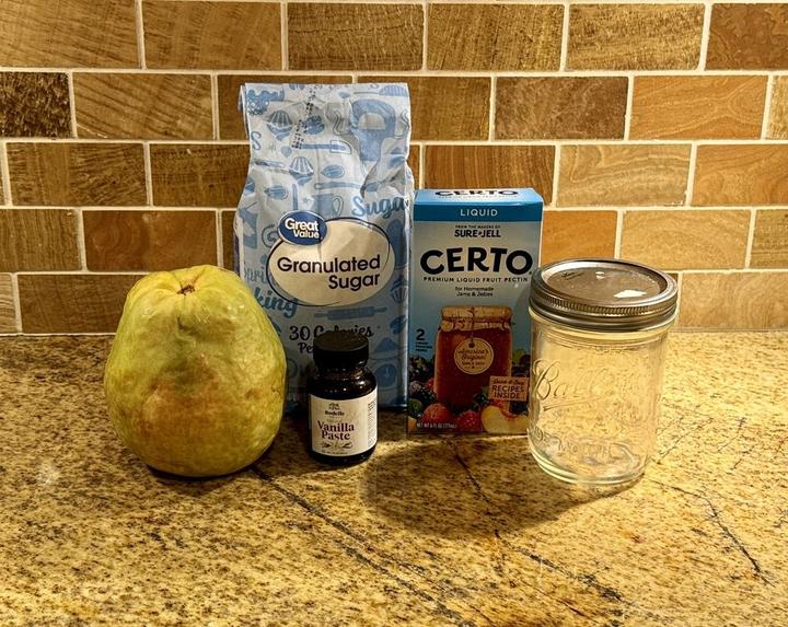 Guava Jam Ingredients on the Counter: Sugar, liquid pectin, fresh pink guava, vanilla bean paste, large ball jar