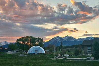 Growing Dome greenhouse backed by the Cascade peaks