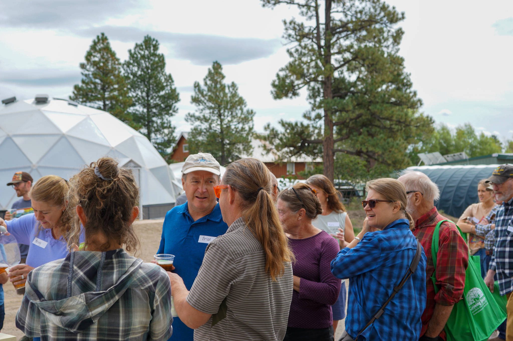 Group of Growing Dome owners mingling outside the 42' Growing Dome.