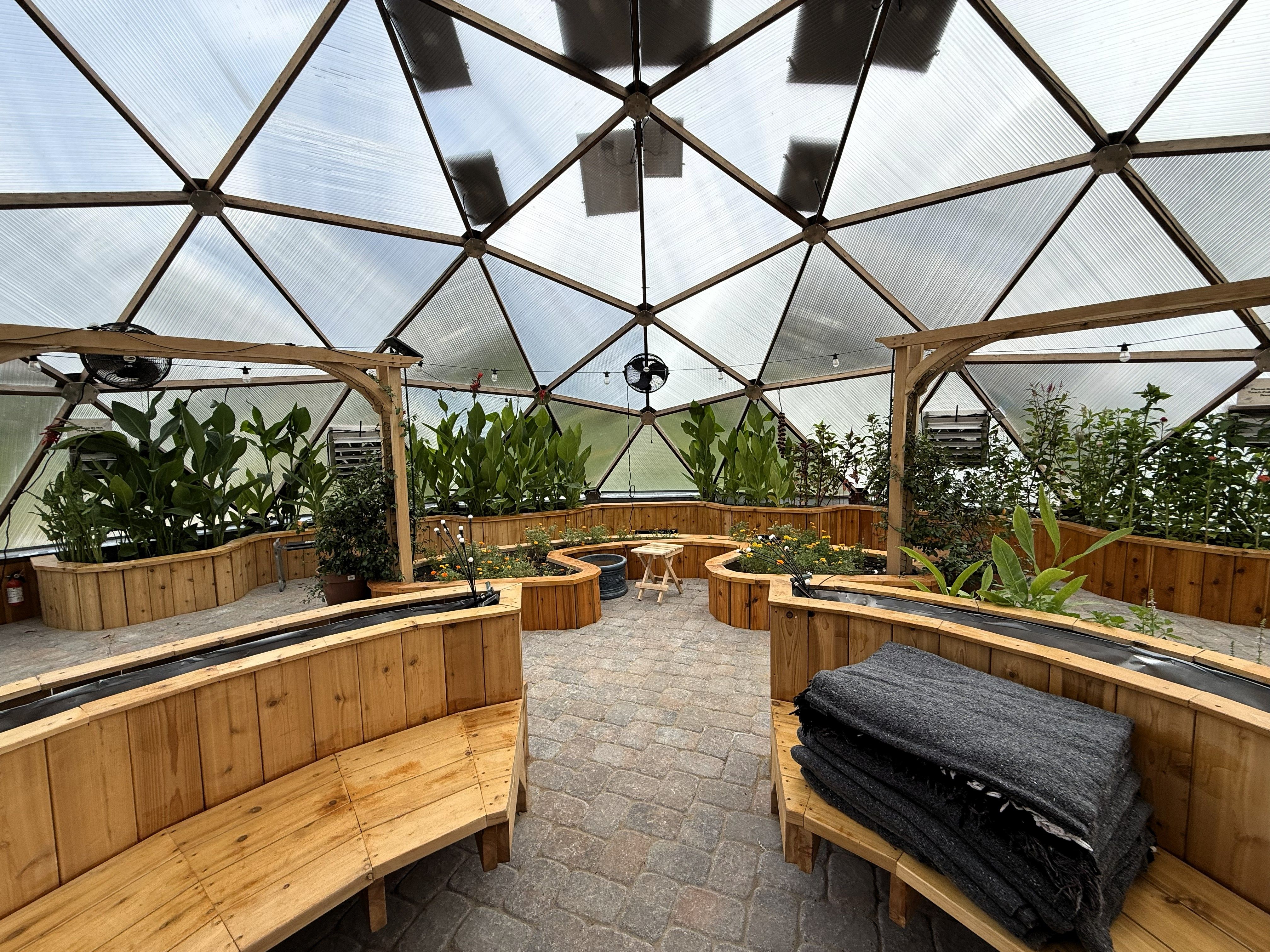 Kula Kamala thoughtful organic design inside geodome greenhouse with seating areas