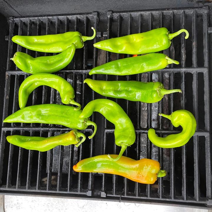 fresh green chiles placed on a grill