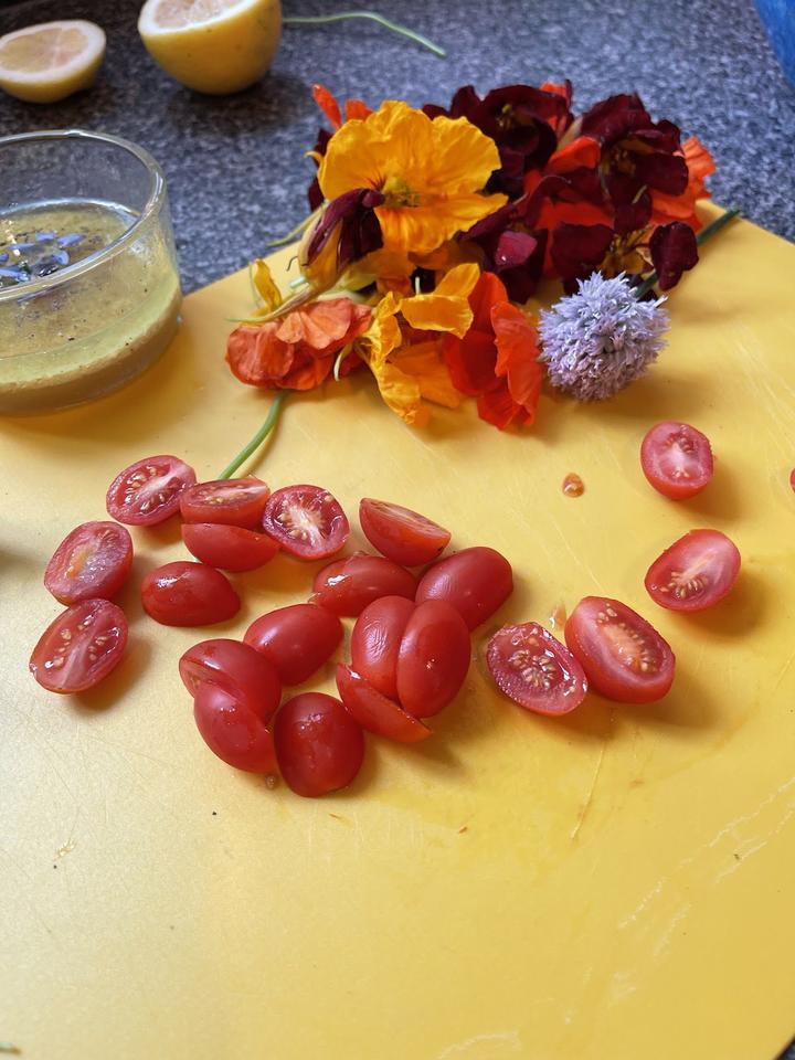 Dome Grown Grape Tomatoes & Nasturtium on a cutting board waiting to top your salad