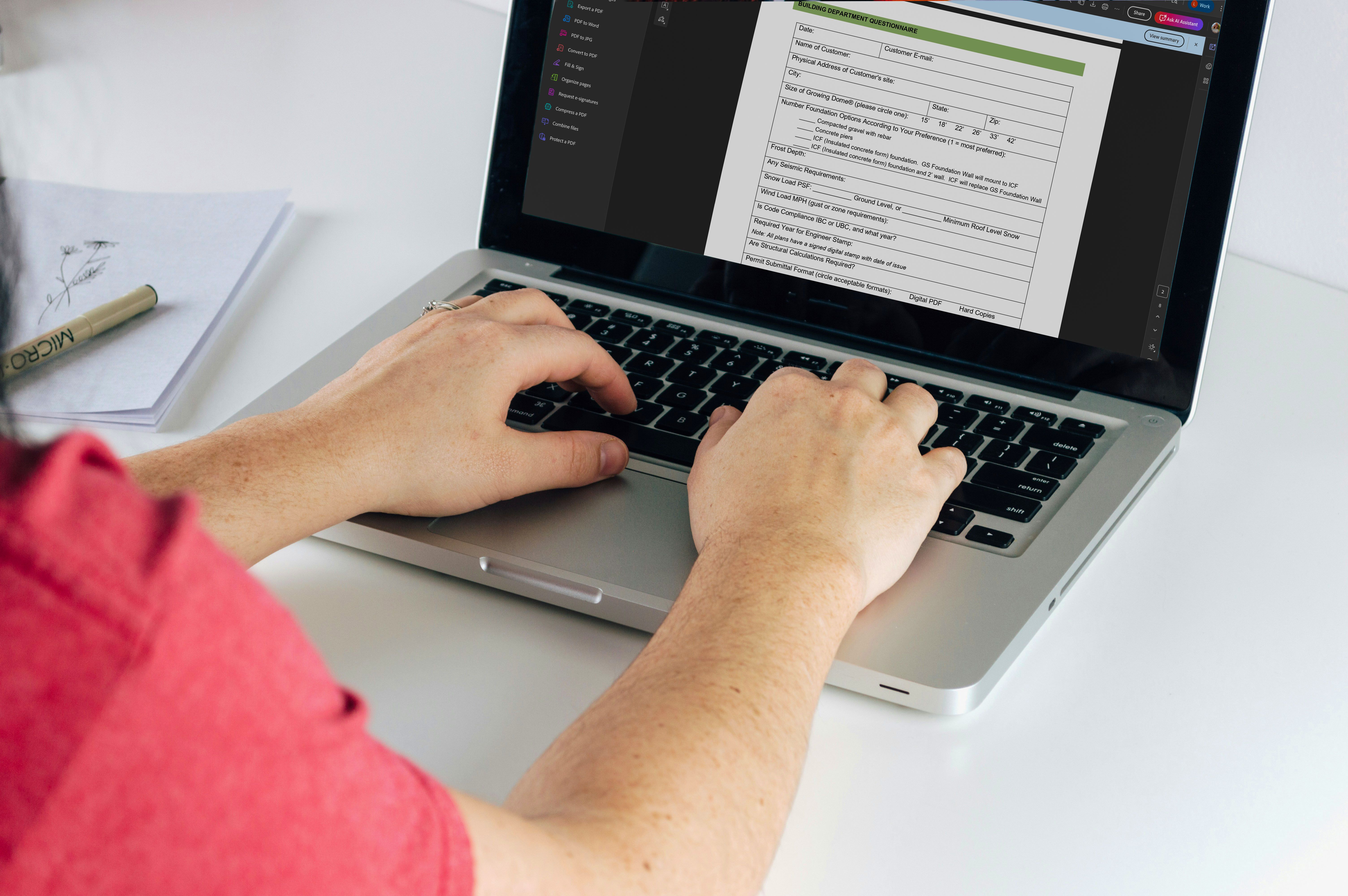 person on a laptop filling out a building department questionnaire