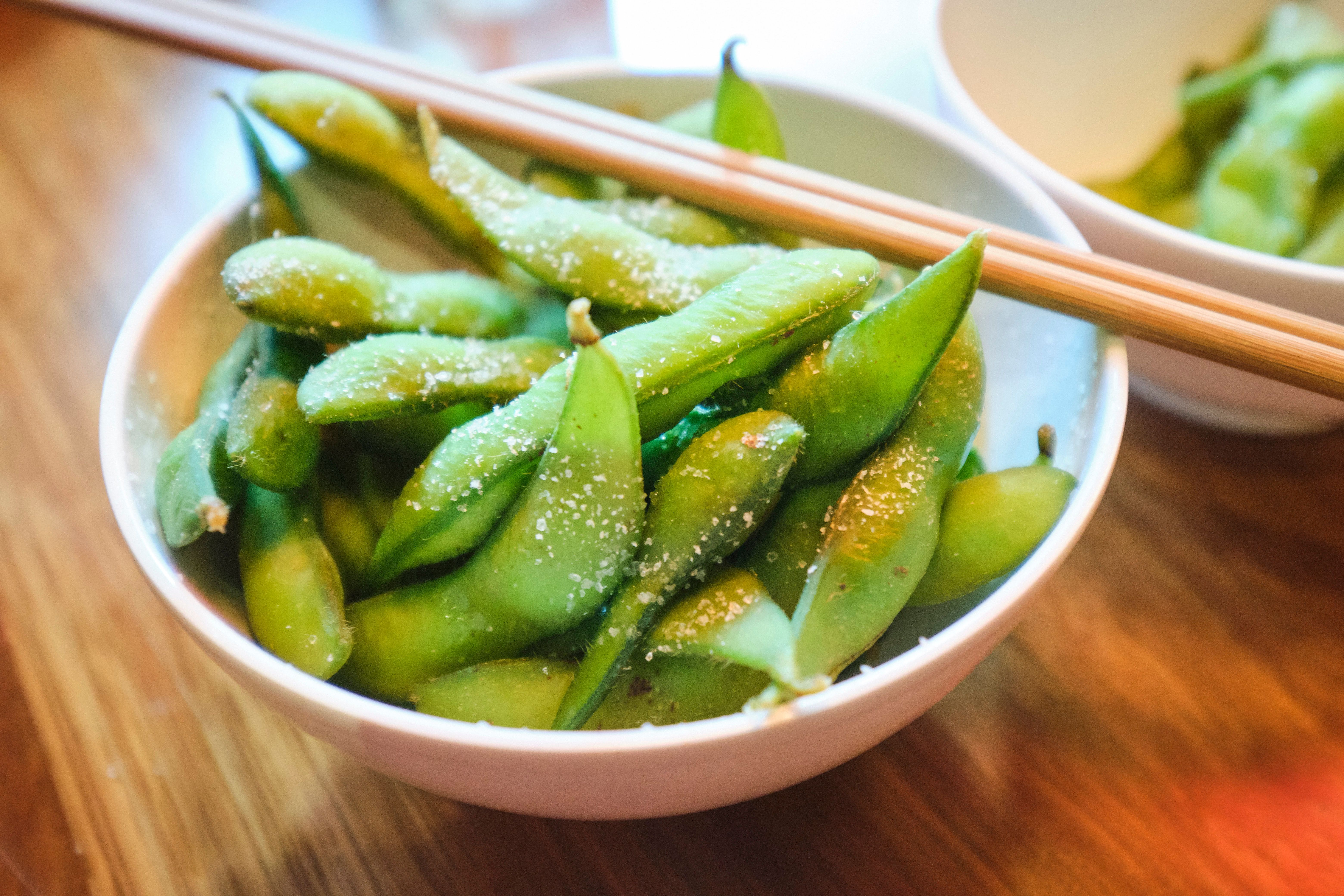 salted edamame pods in a bowl with chopsticks
