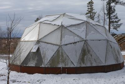 growing dome greenhouse crusted with icy snow