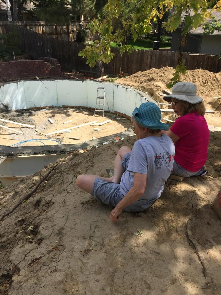 cindy and her friend watching the climate battery greenhouse be built