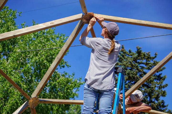 women doing an easy installation on a wooden greenhouse kit