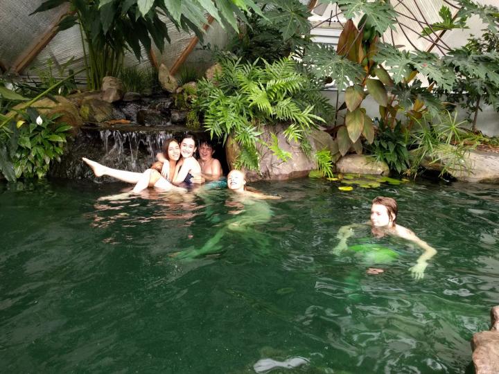 kids in tropical greenhouse pond