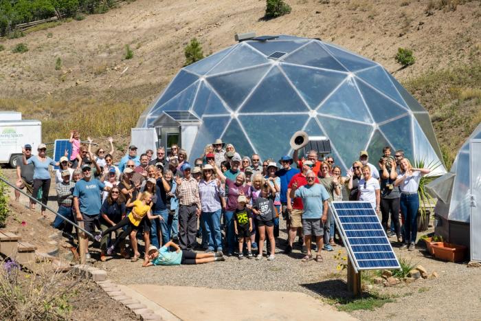 Large group of people gathered outside a Growing Dome