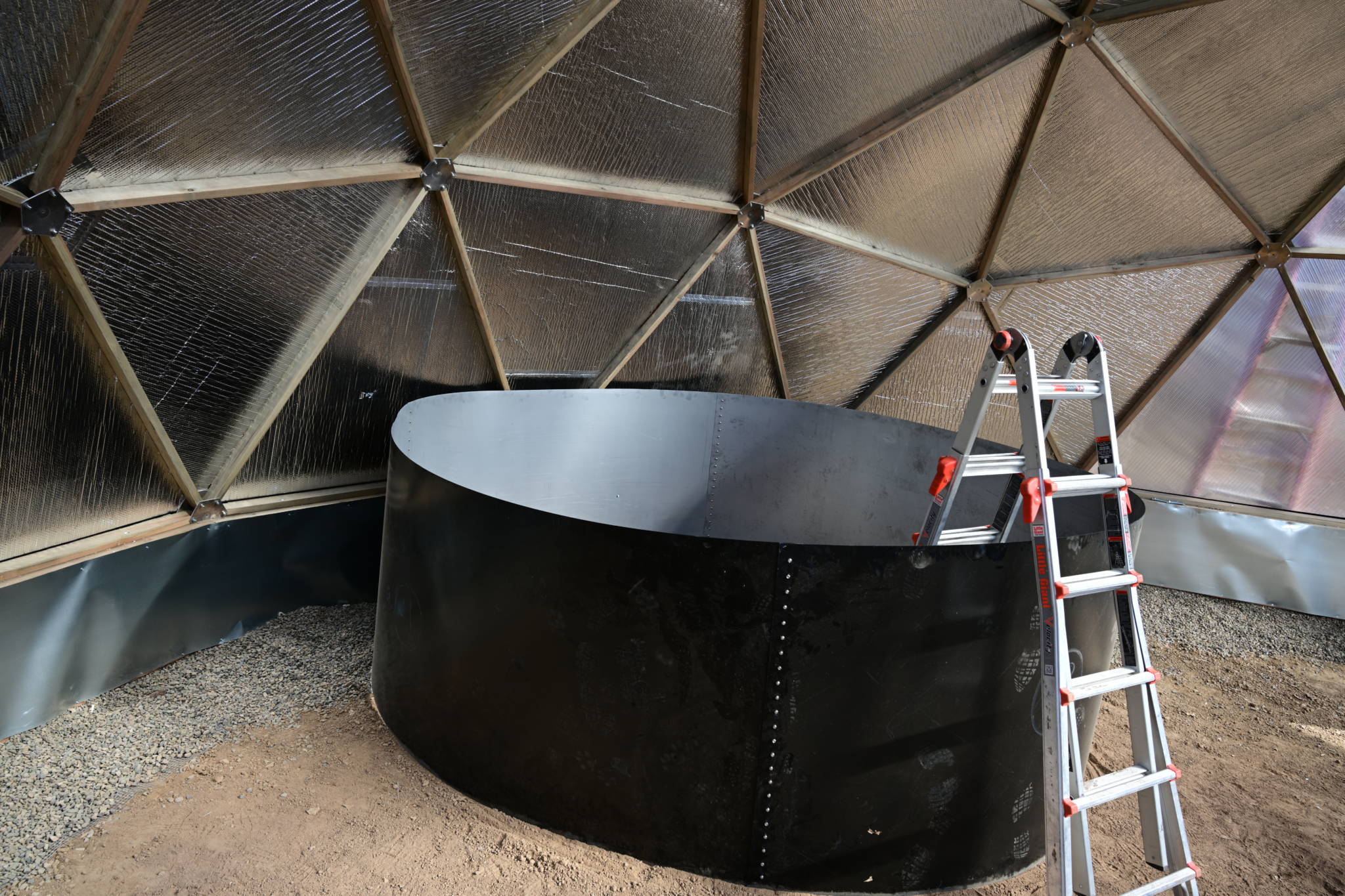 Volunteers building the above-ground pond inside a Growing Dome in Pennsylvania