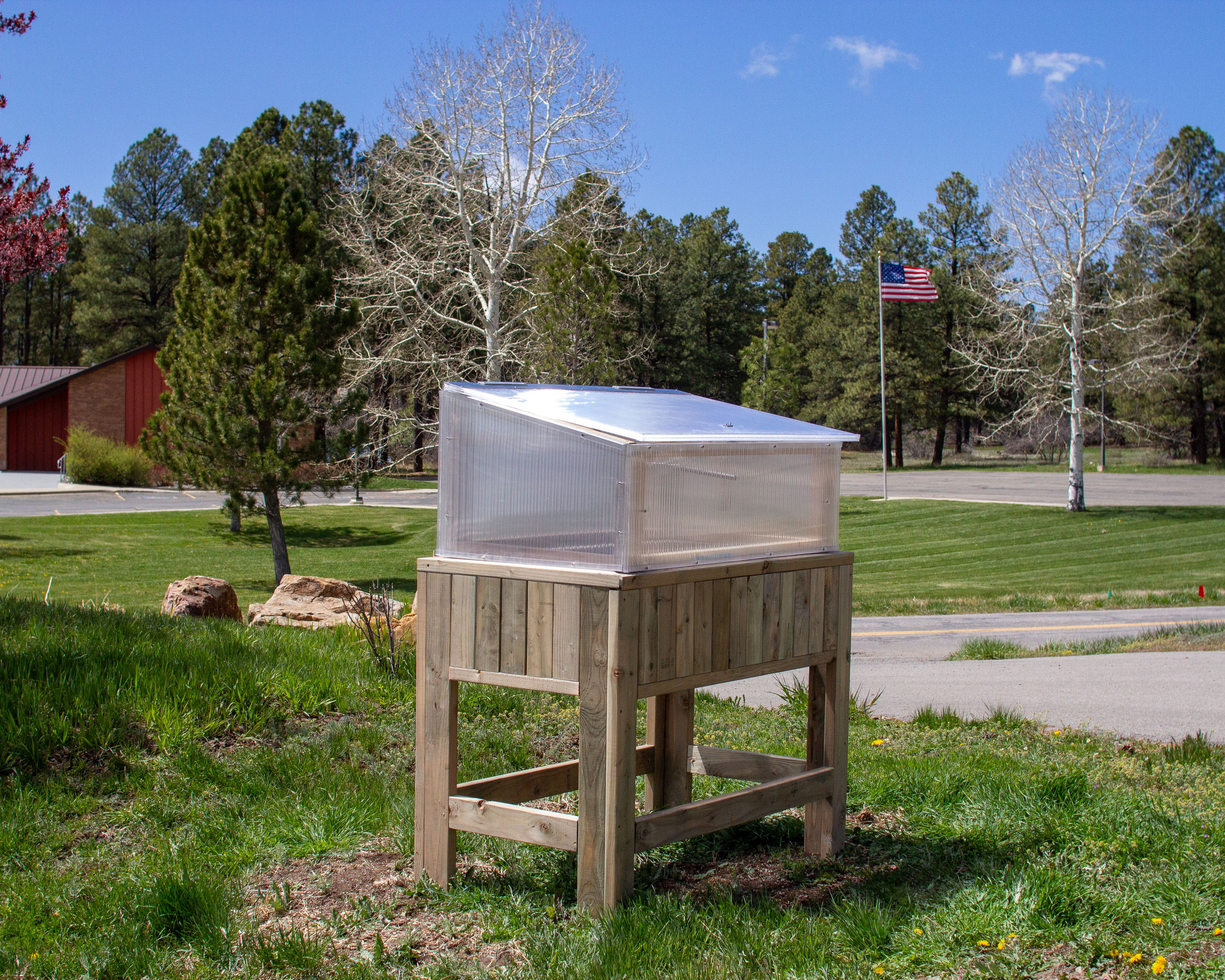 polycarbonate cold frame on an elevated planter box