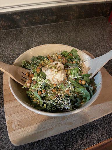 Completed Pistachio And Chickpea Caesar Salad and tongs