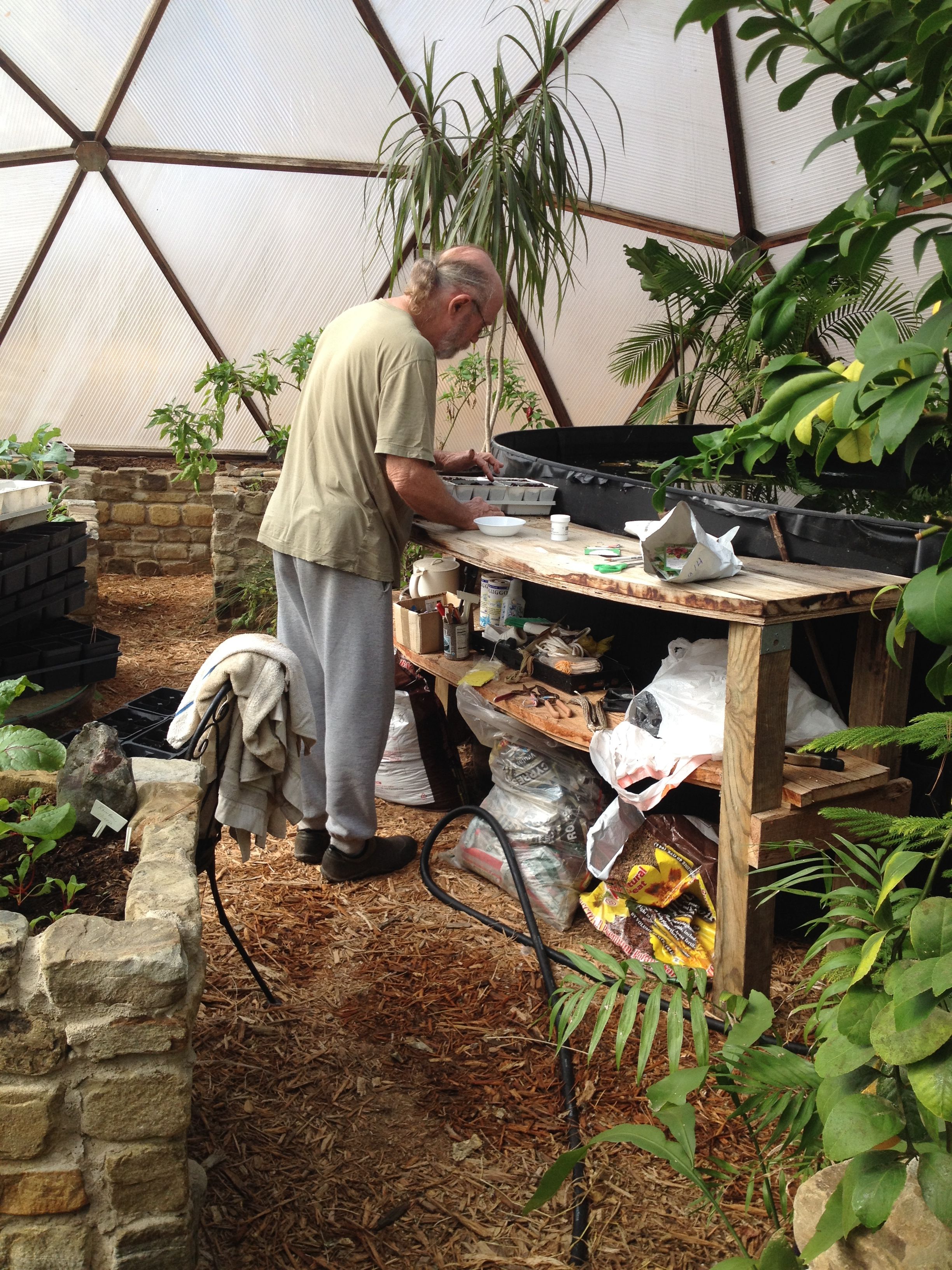 Grower starting seeds at a workbench inside a Growing Dome in Natchitoches, Louisiana