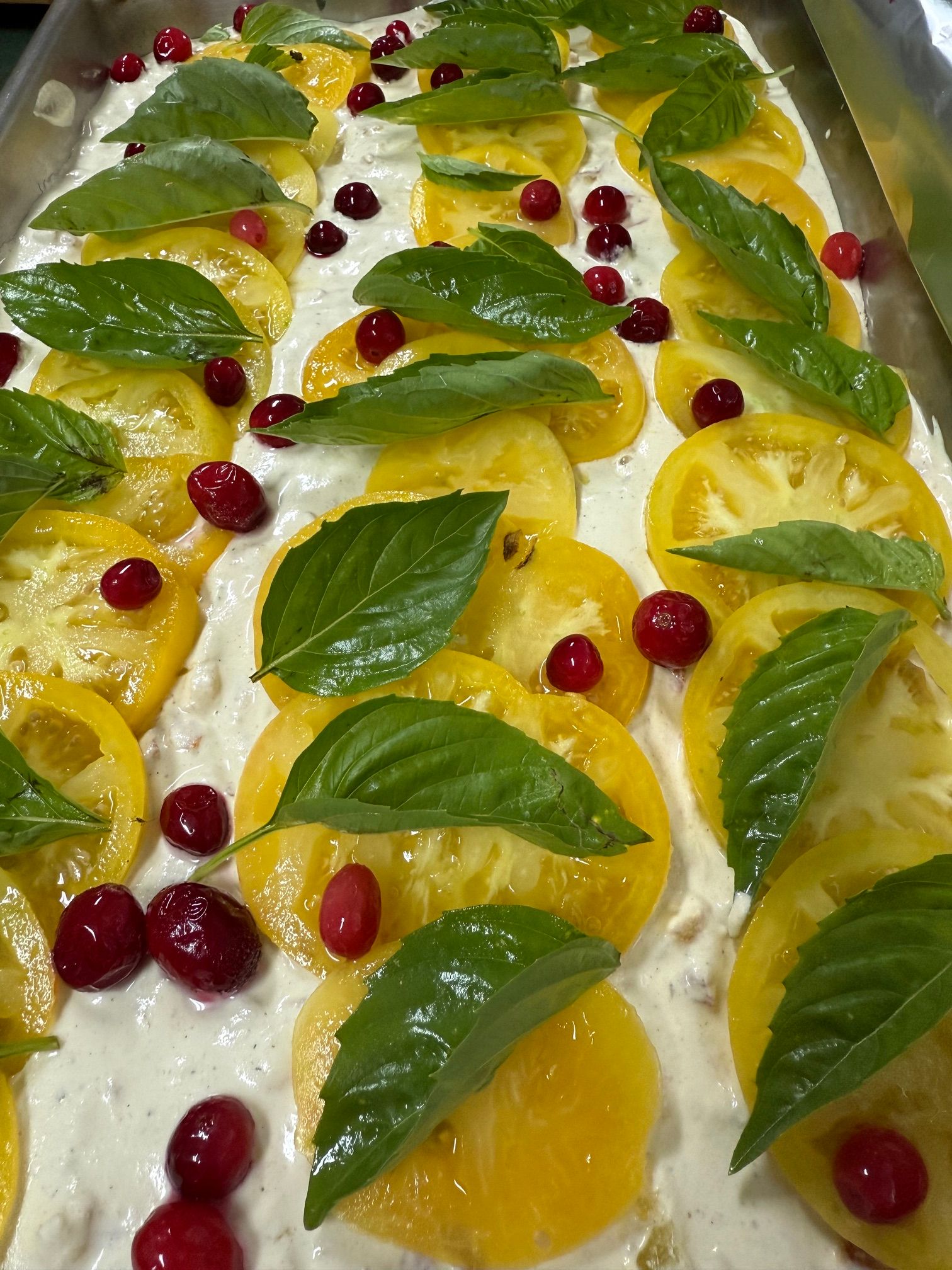 Delicious food at Kula Kamala yellow tomatoes topped with basil leaves and possibly cranberries