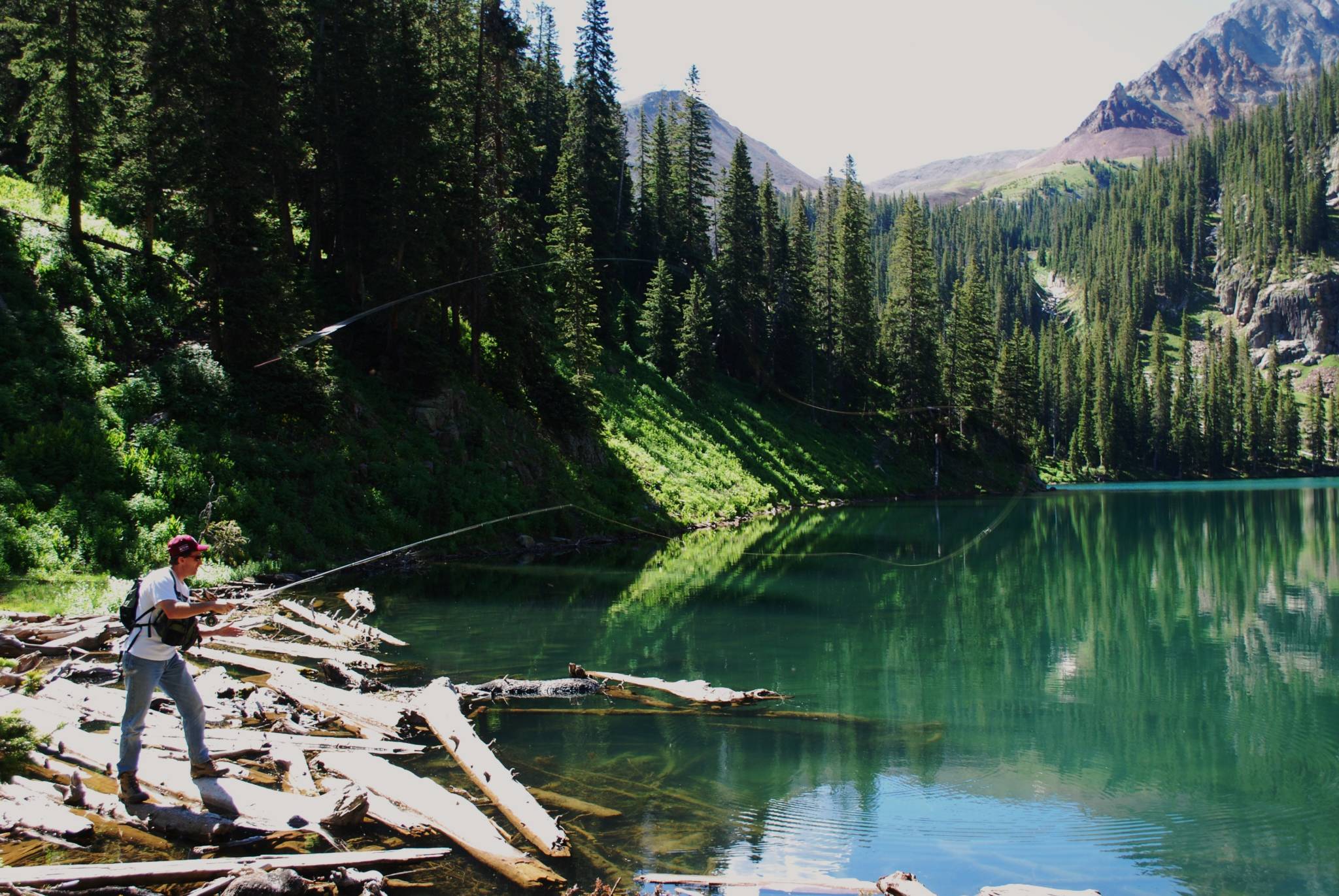 Man fly fishing in a high alpine lake