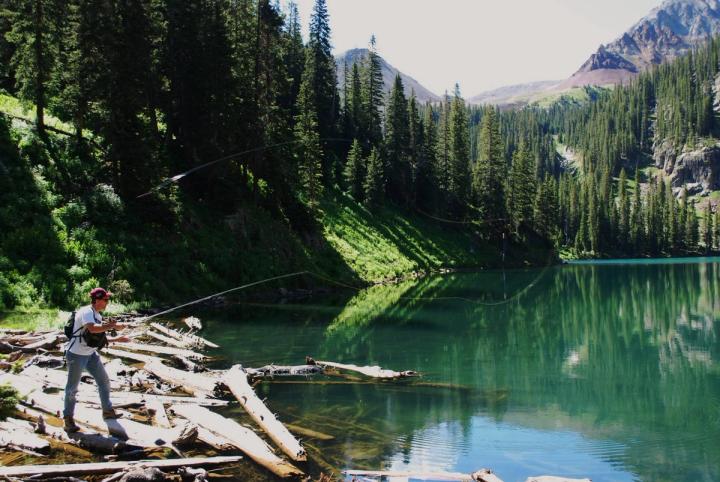 Man fly fishing in a high alpine lake
