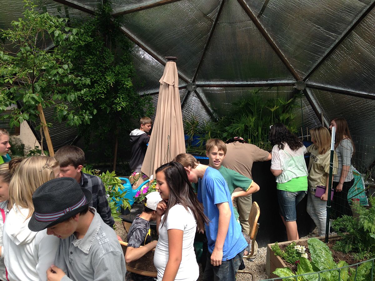 Students exploring a Growing Dome community greenhouse