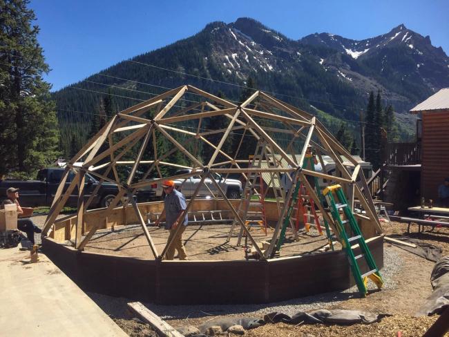 Community volunteers assembling a Growing Dome frame in Cooke City, Montana