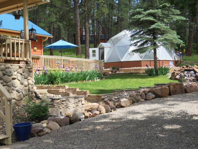 view of someone's house and growing dome greenhouse well landscaped and aesthetically pleasing