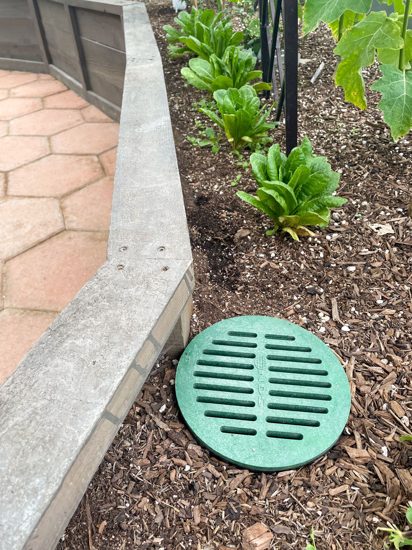 landscaping grate in a raised garden bed
