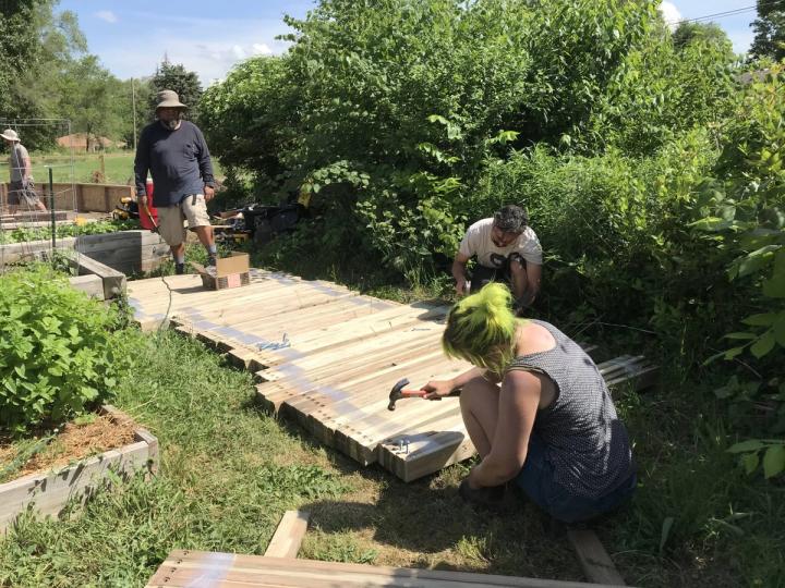 City Sprouts volunteers and employees preparing struts to be installed in a Growing Dome greenhouse