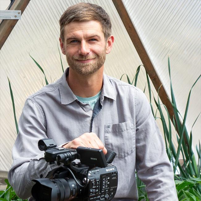 Headshot of Growing Spaces' Videographer, Shane Martin Smith, inside a 26' Growing Dome.