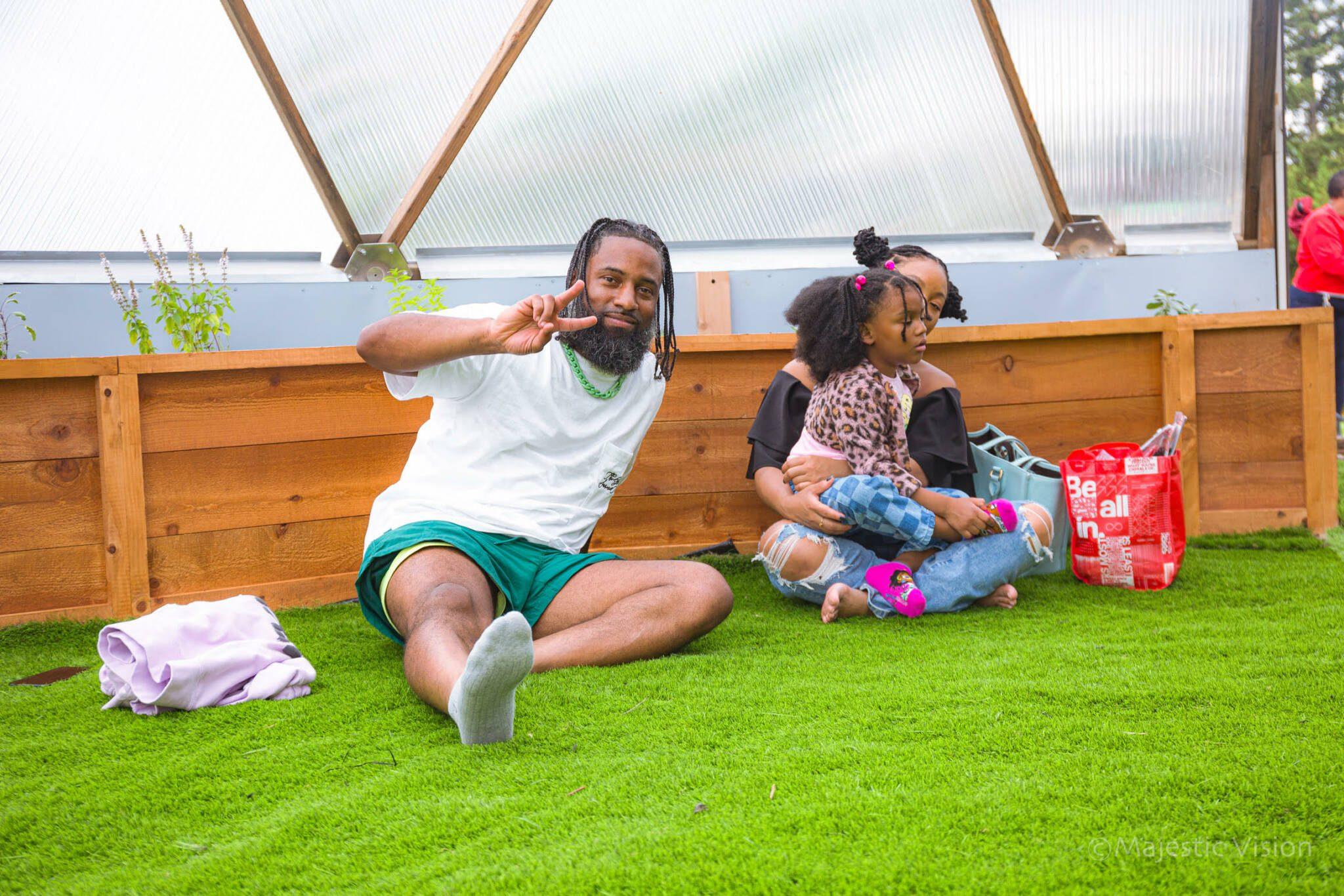 People gathered on the grass inside the Prolific Oxygen Dome