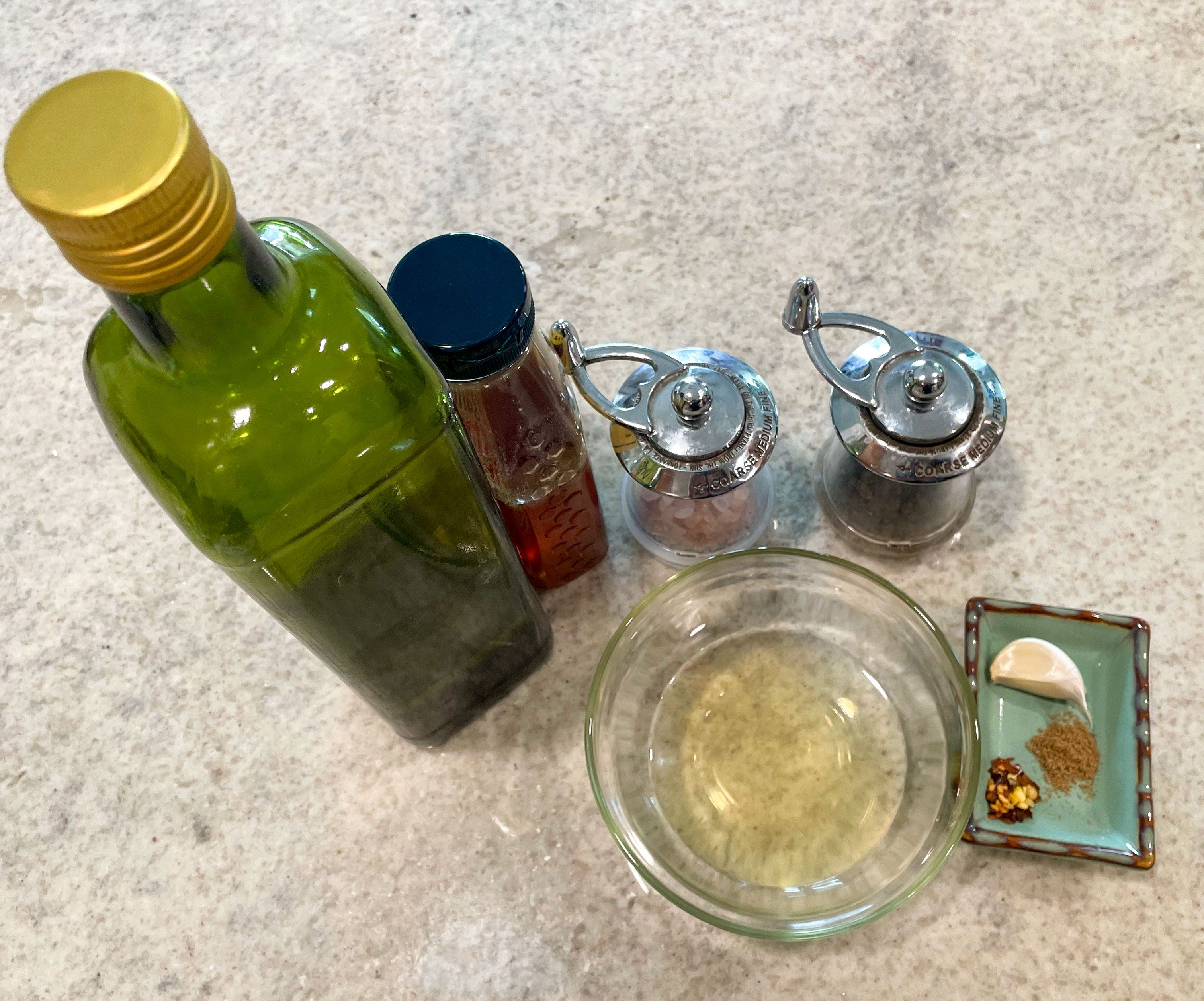 vinaigrette ingredients top down on a counter oil honey vinegar spices
