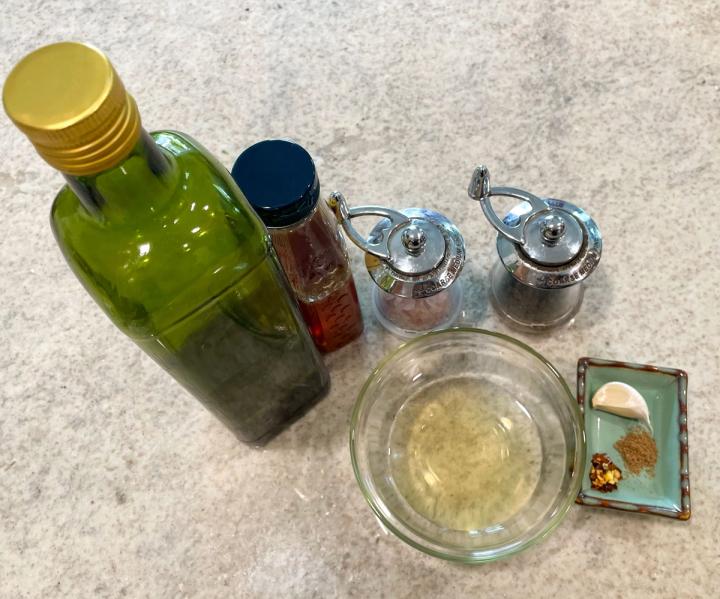 vinaigrette ingredients top down on a counter oil honey vinegar spices