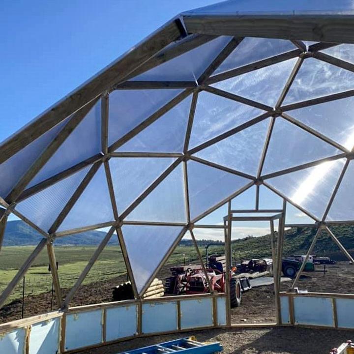 greenhouse being built in the rocky mountains panels on