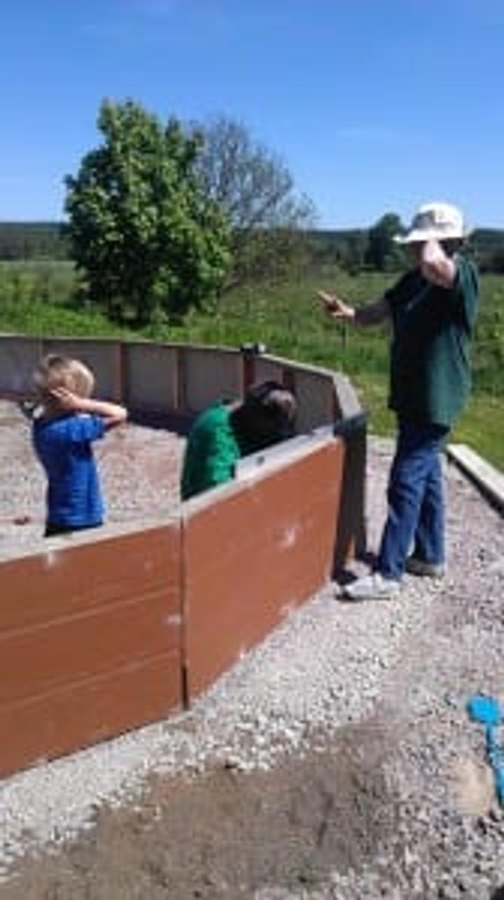 Crew attaching wall sections of a Growing Dome greenhouse together