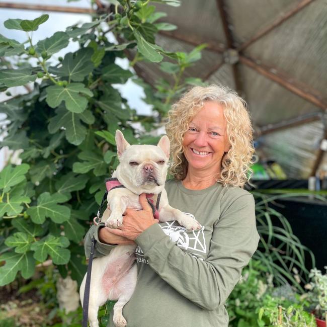 Portrait of Growing Dome Adviser, Kelly Jones and her dog, inside a 22' Growing Dome at Growing Spaces.