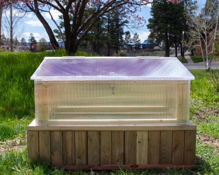 Polycarbonate cold frame on a raised bed