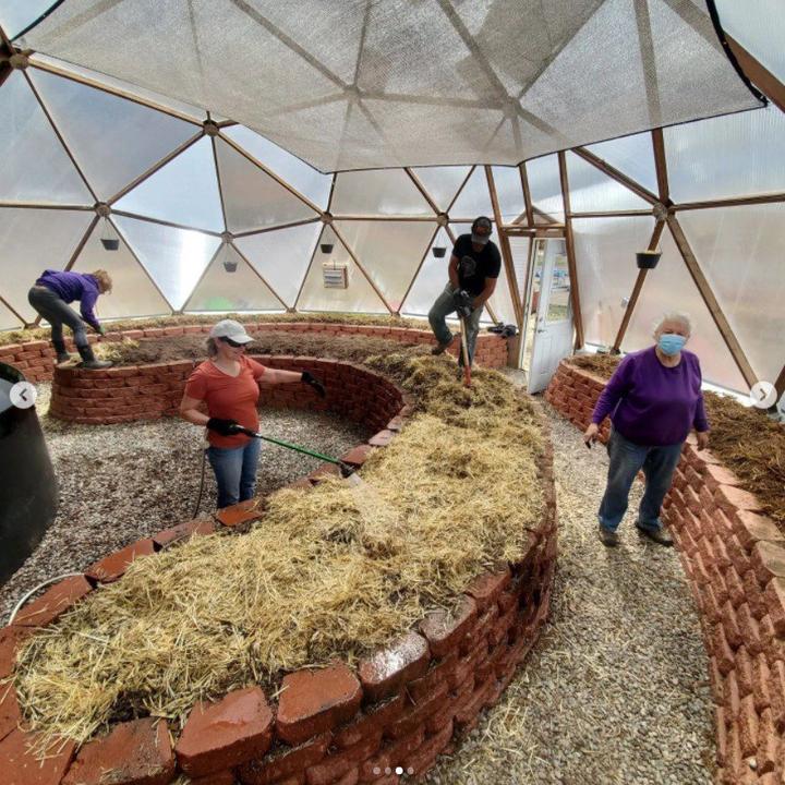 volunteers working in a community greenhouse