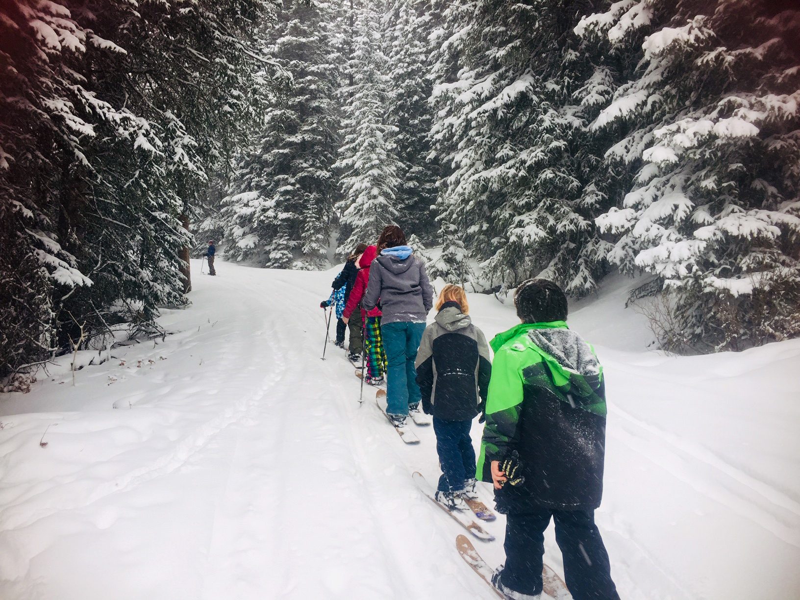 Cooke City students skiing through the snow near their Growing Dome
