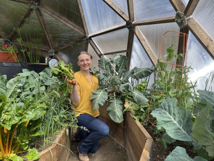 woman holding winter crops in dome