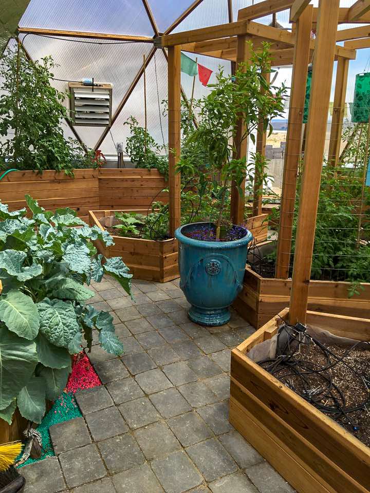 a louvered fan in the polycarbonate of a geodesic greenhouse