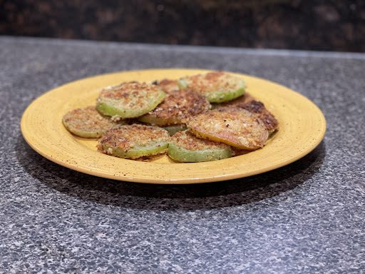 finished fried green tomatoes on yellow  plate