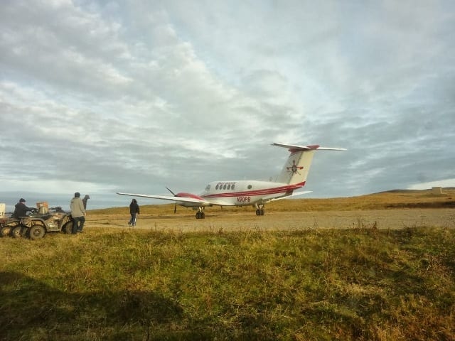 greenhouse installers travel on small plane