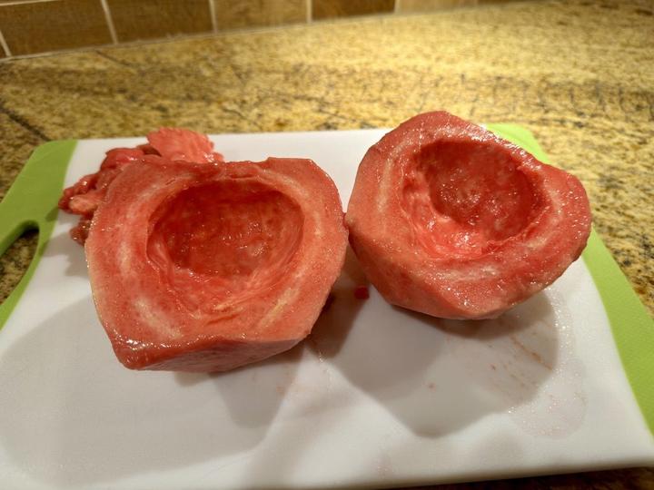 guava cut in half on a cutting board